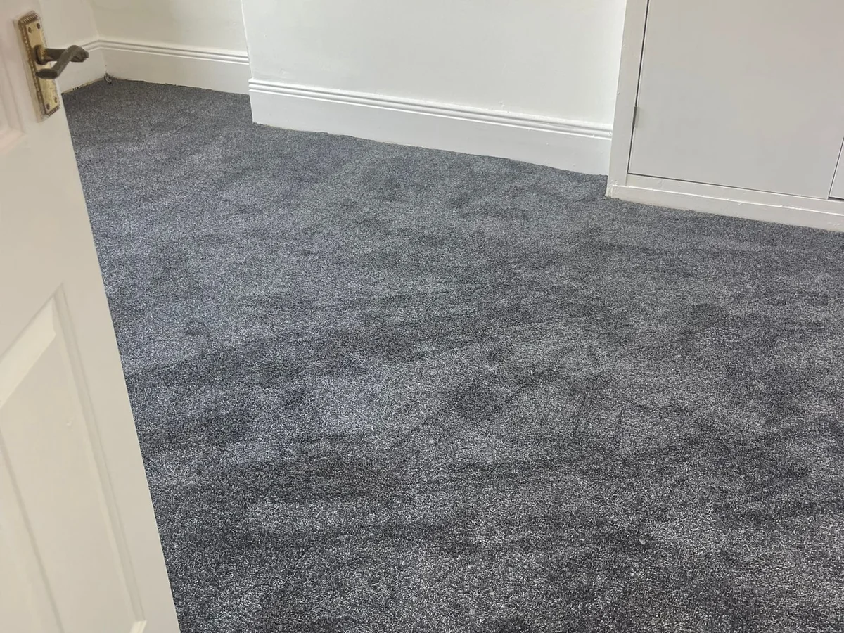 Dark grey carpet freshly fitted in a bedroom — carpet fitters covering Darras Hall