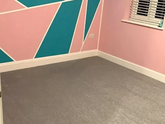 bedroom-carpet-grey-teal-feature-wall-newcastle-foxglove-flooring Grey carpet against a teal and pink geometric feature wall — carpet fitters covering Benton