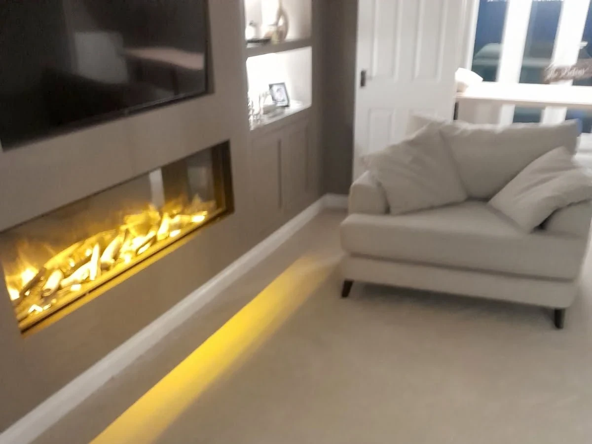Cream carpet in a living room with media wall and inset fire — carpet fitters covering Cullercoats