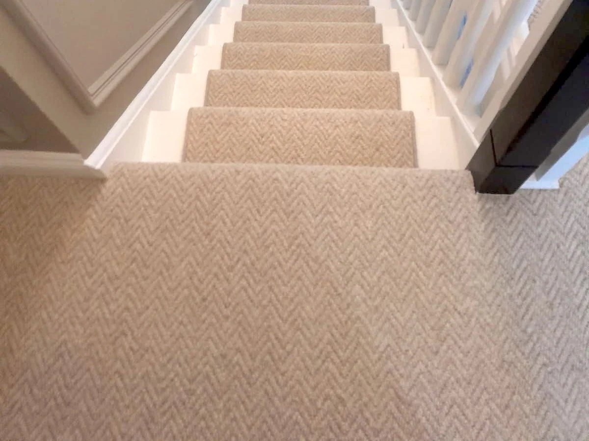 Beige herringbone-weave carpet up a straight staircase — carpet fitters covering Cullercoats