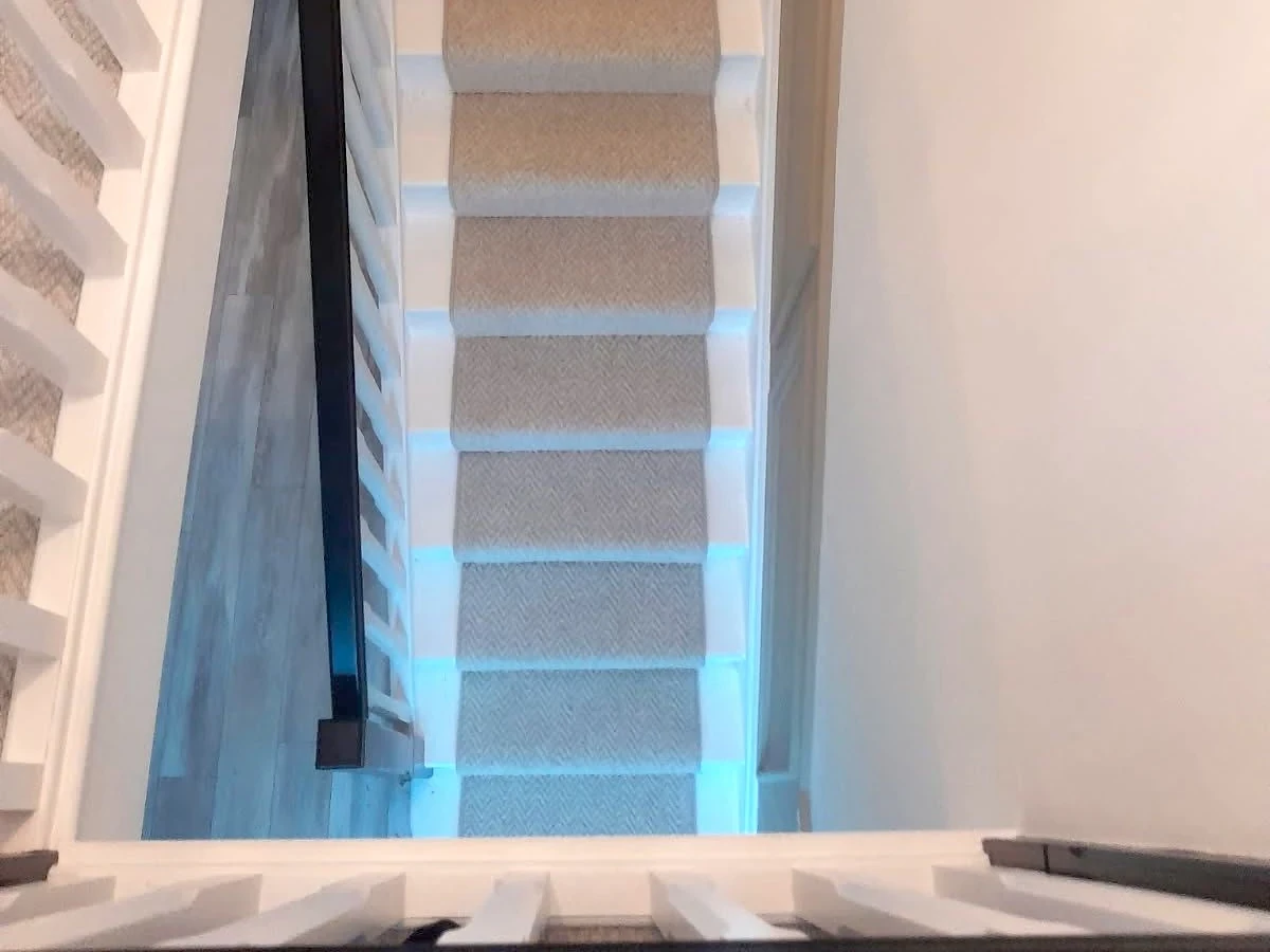 staircase-carpet-herringbone-beige-top-down-newcastle-foxglove-flooring Beige herringbone-weave stair carpet seen from the landing — carpet fitters covering Dudley Annitsford